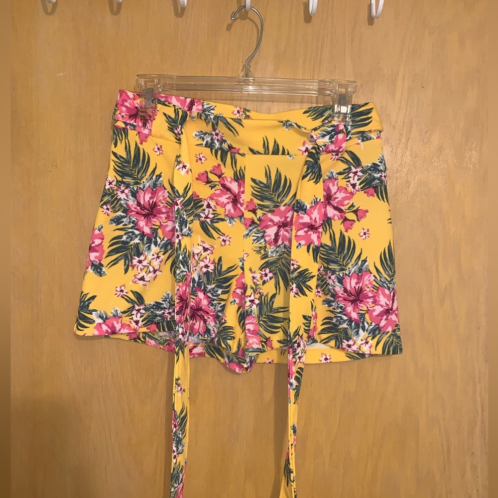 Yellow, floral shorts with a tie.